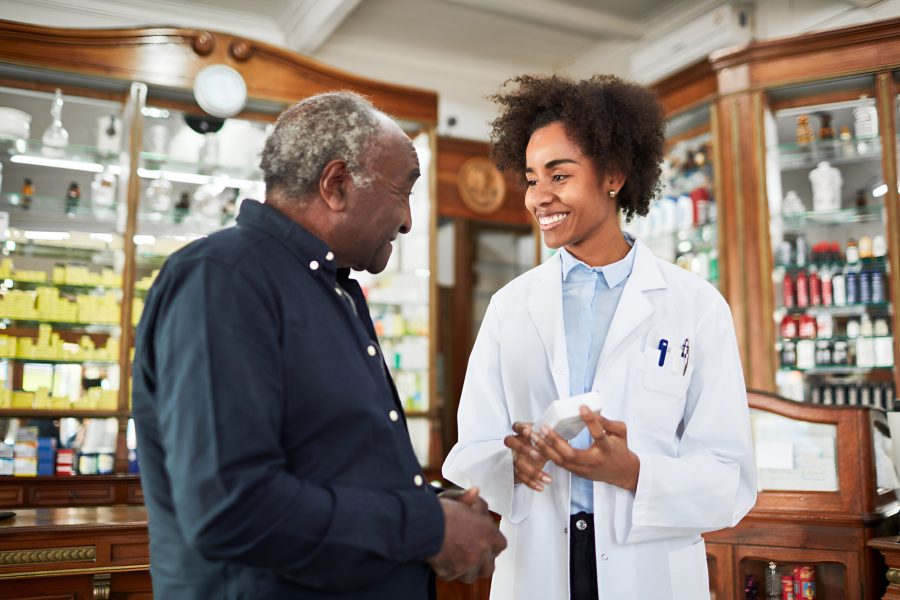 Female chemist assisting senior customer